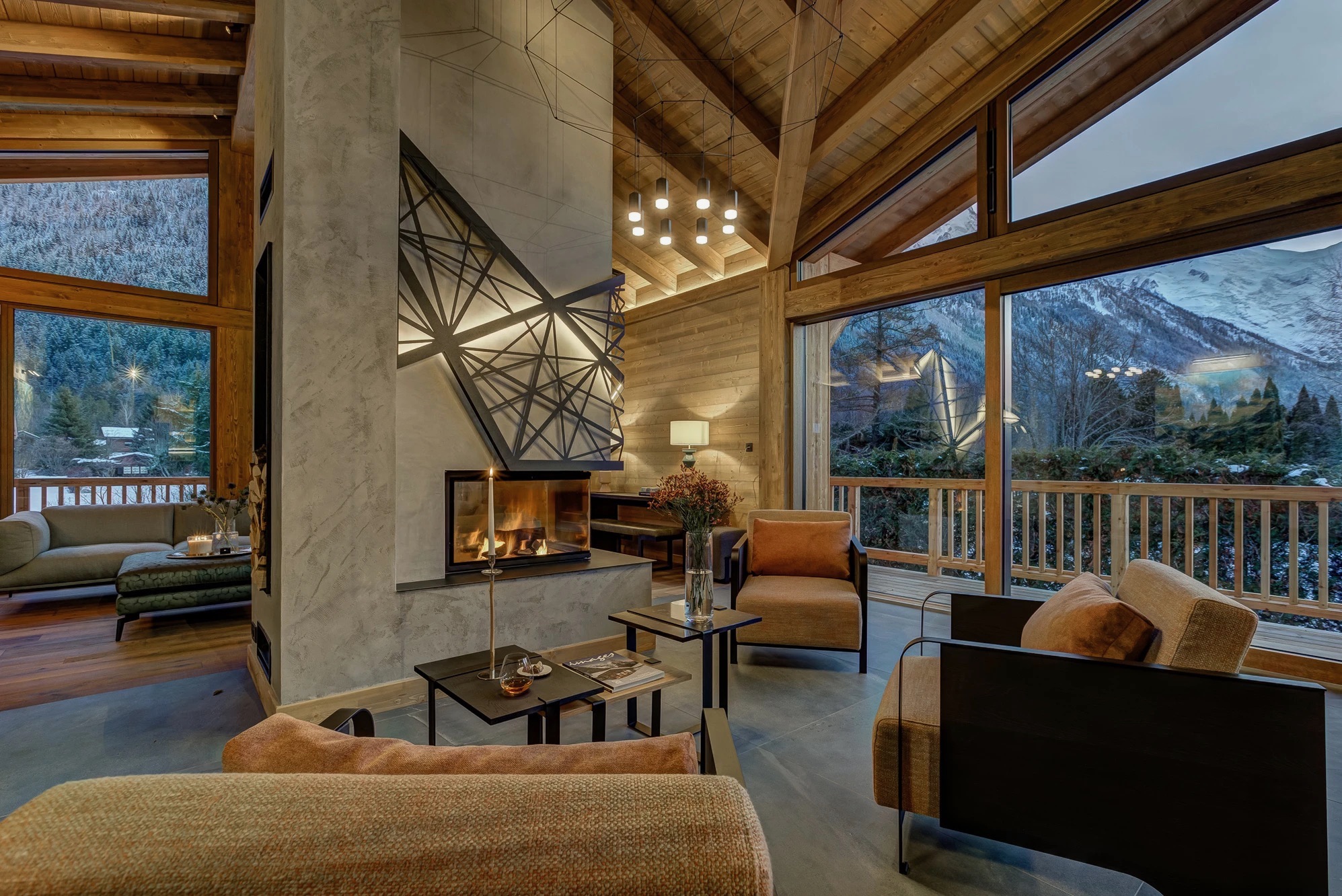Vaulted open-plan main interior of Chalet Mélèzes with timber ceiling and pendant lighting