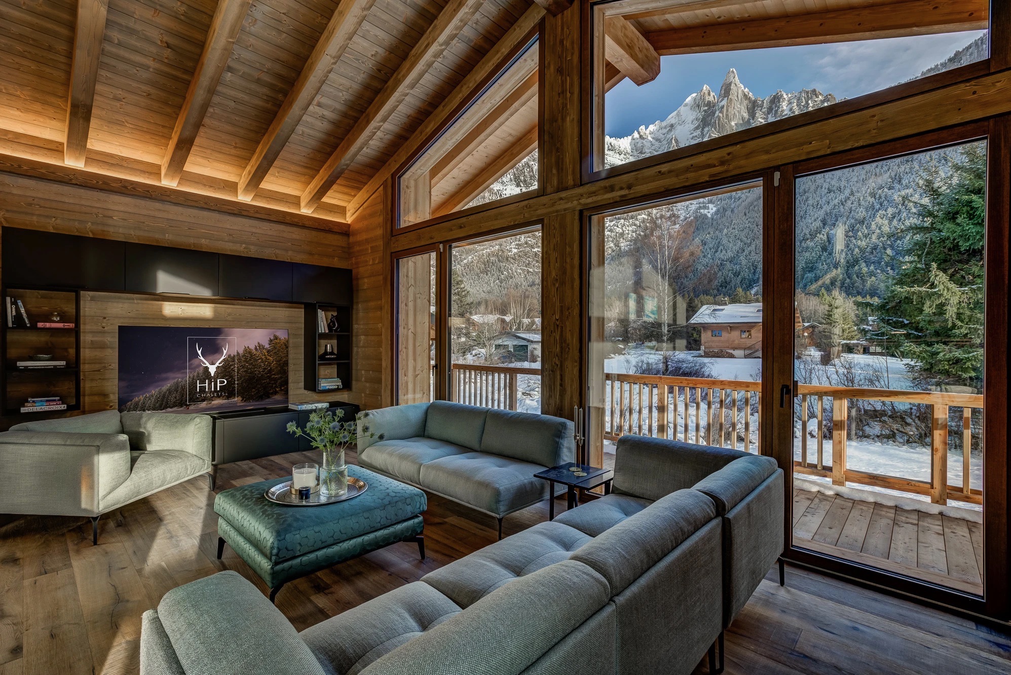 Relaxed TV lounge area with deep seating and warm timber walls
